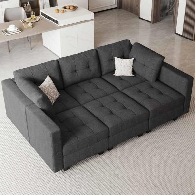 Comfortable black sofa with throw pillows in an optometry clinic lobby setting for patient relaxation.