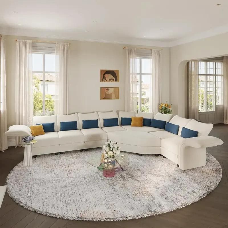 Bright, modern living room with spacious white sectional sofa, decorative cushions, and elegant decor, perfect for comfort and style in a sophisticated home setting.