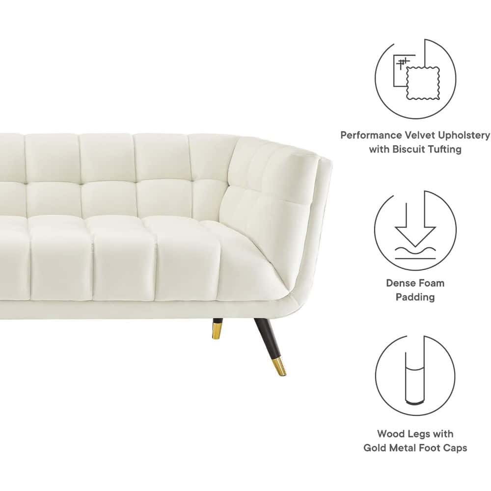 Elegant white velvet sofa with tufted design and gold metal foot caps, perfect for contemporary living room decor and stylish seating solutions.