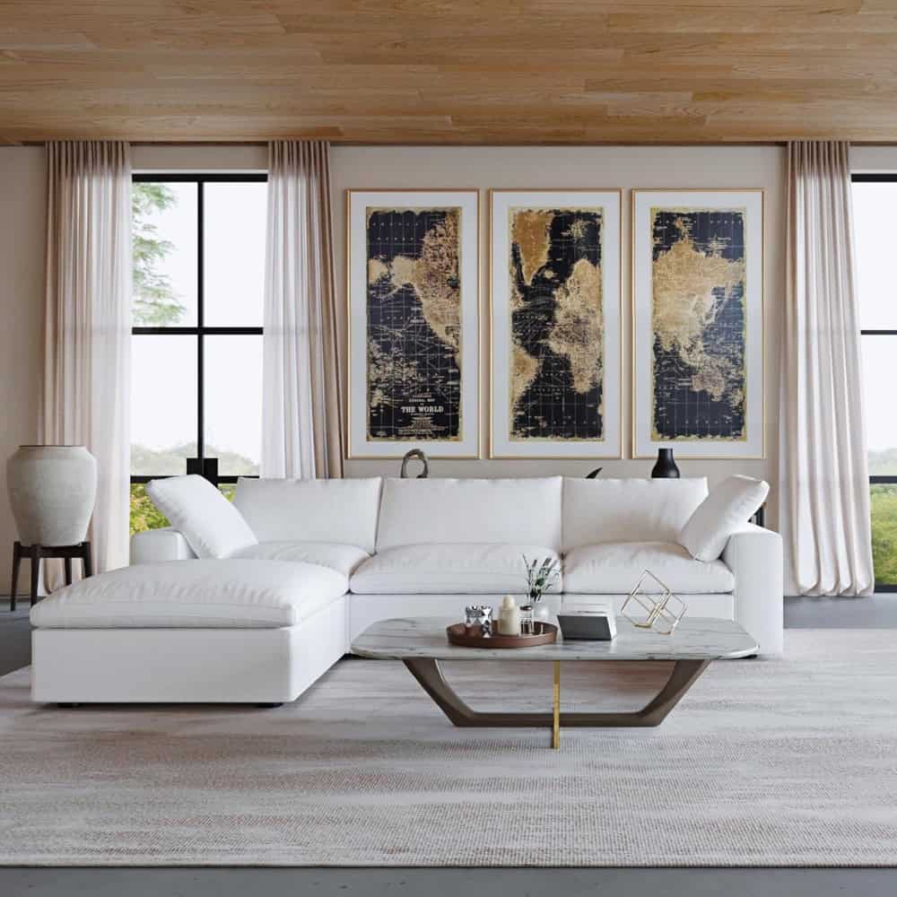 Bright living space featuring world map art, elegant white sofa, and spacious windows for an inviting atmosphere.