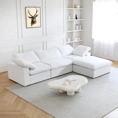 Elegant white sectional sofa with plush cushions, perfect for contemporary living rooms and stylish interior decor. Comfortable seating option for relaxing or entertaining guests.