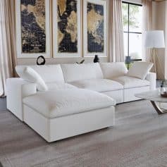 Spacious white velvet sectional sofa in a contemporary living room with large windows, neutral curtains, and minimalist decor, perfect for stylish home relaxation.