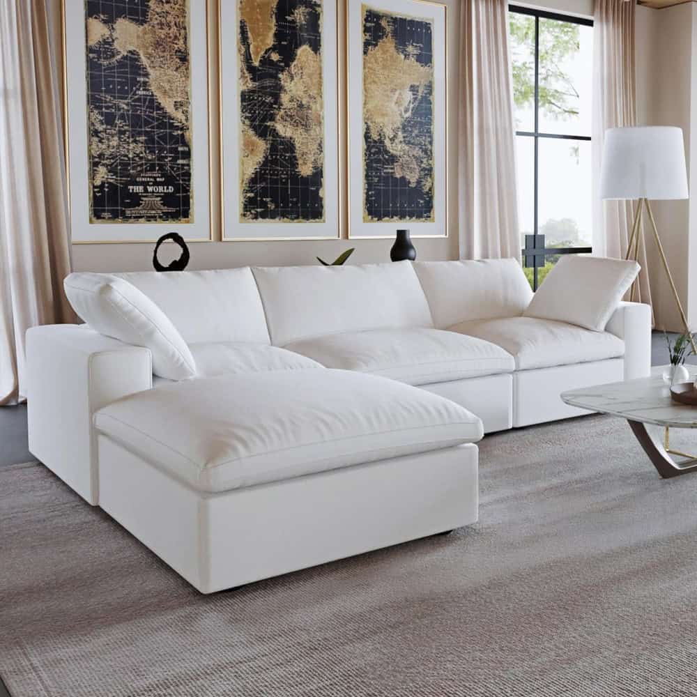 Spacious white velvet sectional sofa in a contemporary living room with large windows, neutral curtains, and minimalist decor, perfect for stylish home relaxation.