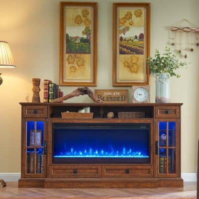 A stunning wooden fireplace mantel with an electric fireplace featuring blue flames, surrounded by decorative items, books, and nature-inspired artwork, creating a cozy living room setting.