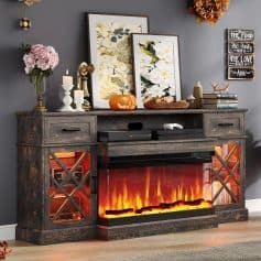 A rustic wooden fireplace console with built-in electric fire, decorative wall art, floral decor, candles, and seasonal accents in a modern living room setting.