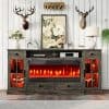 A rustic wooden console with built-in electric fireplace, surrounded by decorative antlers, floral artwork, and modern accents in a stylish living room.