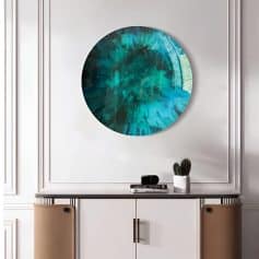 Vibrant blue abstract circular artwork displayed on a stylish white wall in a contemporary interior setting.