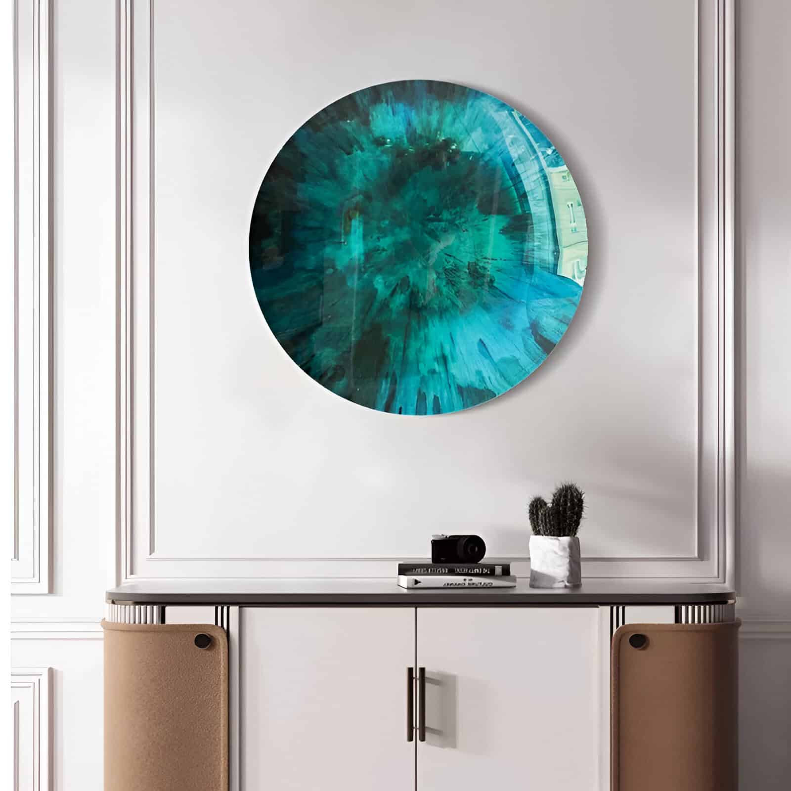 Vibrant blue abstract circular artwork displayed on a stylish white wall in a contemporary interior setting.