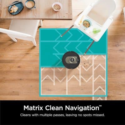 Vacuum robot cleaning a colorful rug in a modern dining area for optimal home hygiene and cleanliness.