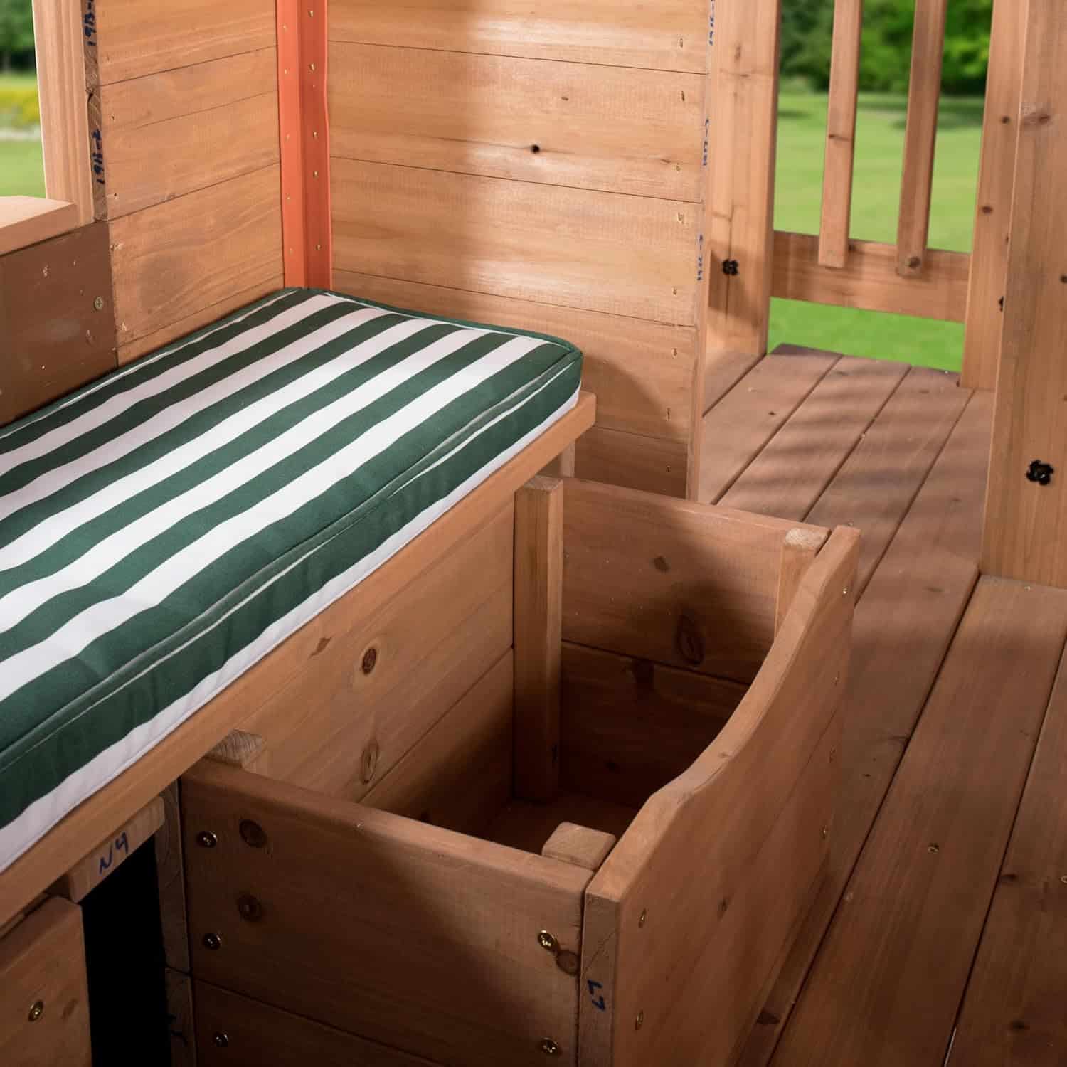 Handcrafted wooden playhouse with built-in bed and storage, perfect for kids' outdoor adventures and imaginative play. Made from durable, natural wood with a striped mattress for comfort.