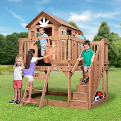 Children playing on a wooden outdoor playhouse in a park, kids enjoying outdoor activities, backyard playset for kids, natural wood playground, kids outdoor wooden playhouse.