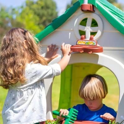 Colorful children's playhouse with a girl and boy playing outdoors, promoting fun, imaginative play, and outdoor activities for kids.