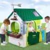 Colorful children's eco-friendly playhouse with solar panels, water-saving features, and garden accessories for outdoor fun and learning; perfect for eco-conscious families.