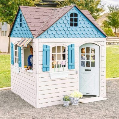 Cute kids playhouse made of durable wood with blue shutters and a striped awning, perfect for outdoor play, imaginative fun, and safe for children. An ideal addition to any child's outdoor space or backyard.
