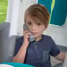 Child playing with a toy phone at Monalisa Store, kids' eyewear and accessories shop.