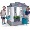 Colorful children's playhouse with embedded interactive features and accessories for creative outdoor fun, ideal for kids' play areas and enhancing imaginative play experiences.