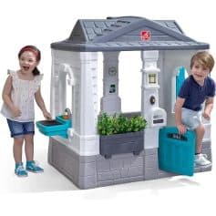 Colorful children's playhouse with embedded interactive features and accessories for creative outdoor fun, ideal for kids' play areas and enhancing imaginative play experiences.