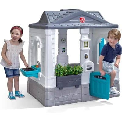 Colorful children's playhouse with embedded interactive features and accessories for creative outdoor fun, ideal for kids' play areas and enhancing imaginative play experiences.