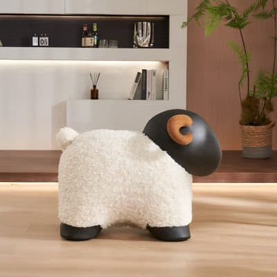 Fluffy plush sheep-shaped chair with black head and brown ear, cozy and playful design for a modern interior space.