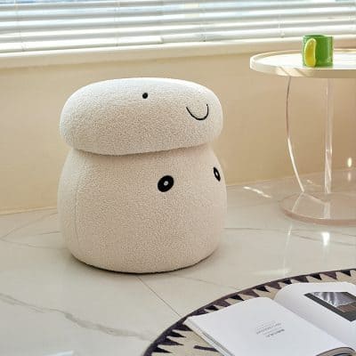 Soft plush stool shaped like a cute smiling face, ideal for home decor and seating, in a cozy living space with a side table and coffee mug, perfect for modern interior design.