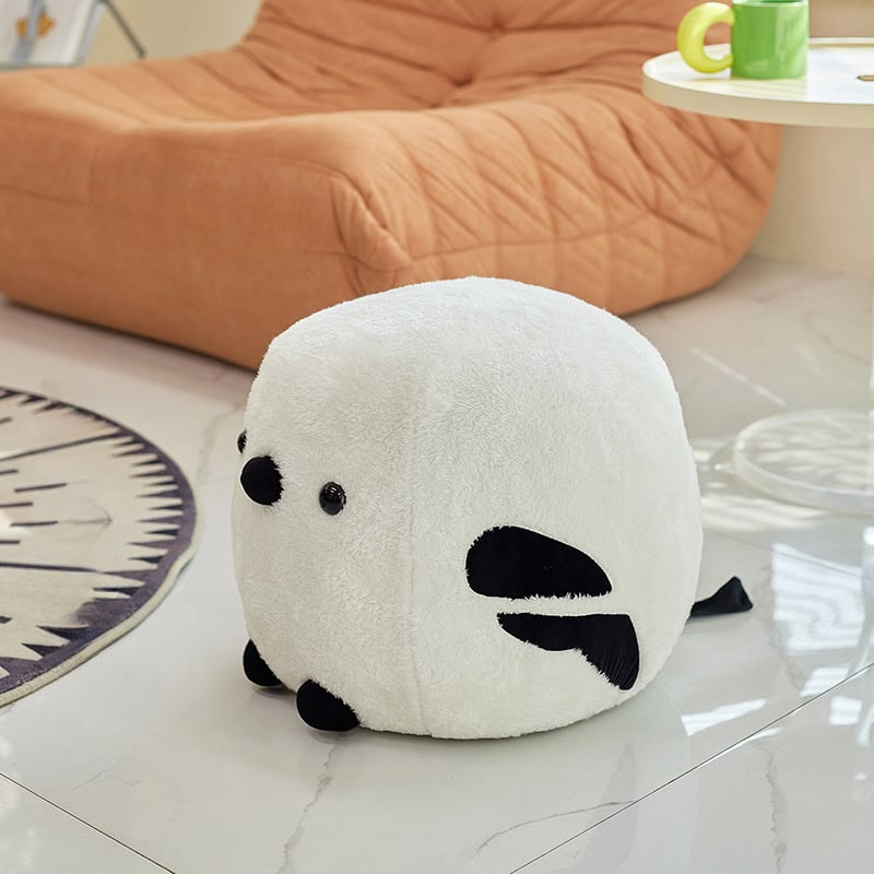Soft plush panda-shaped footrest, ideal for children's rooms and cozy spaces, featuring cute black and white details and comfortable cushioning. Perfect for adding playful decor and relaxation to your home.