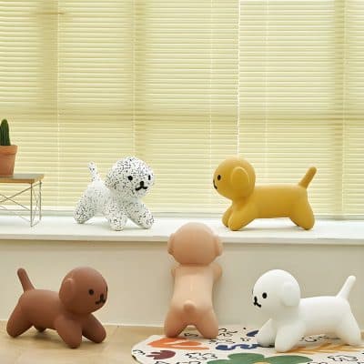 Cute dog-shaped decor toys in various colors on window sill and floor, ideal for children's rooms or playful home decor, emphasizing style, comfort, and fun.