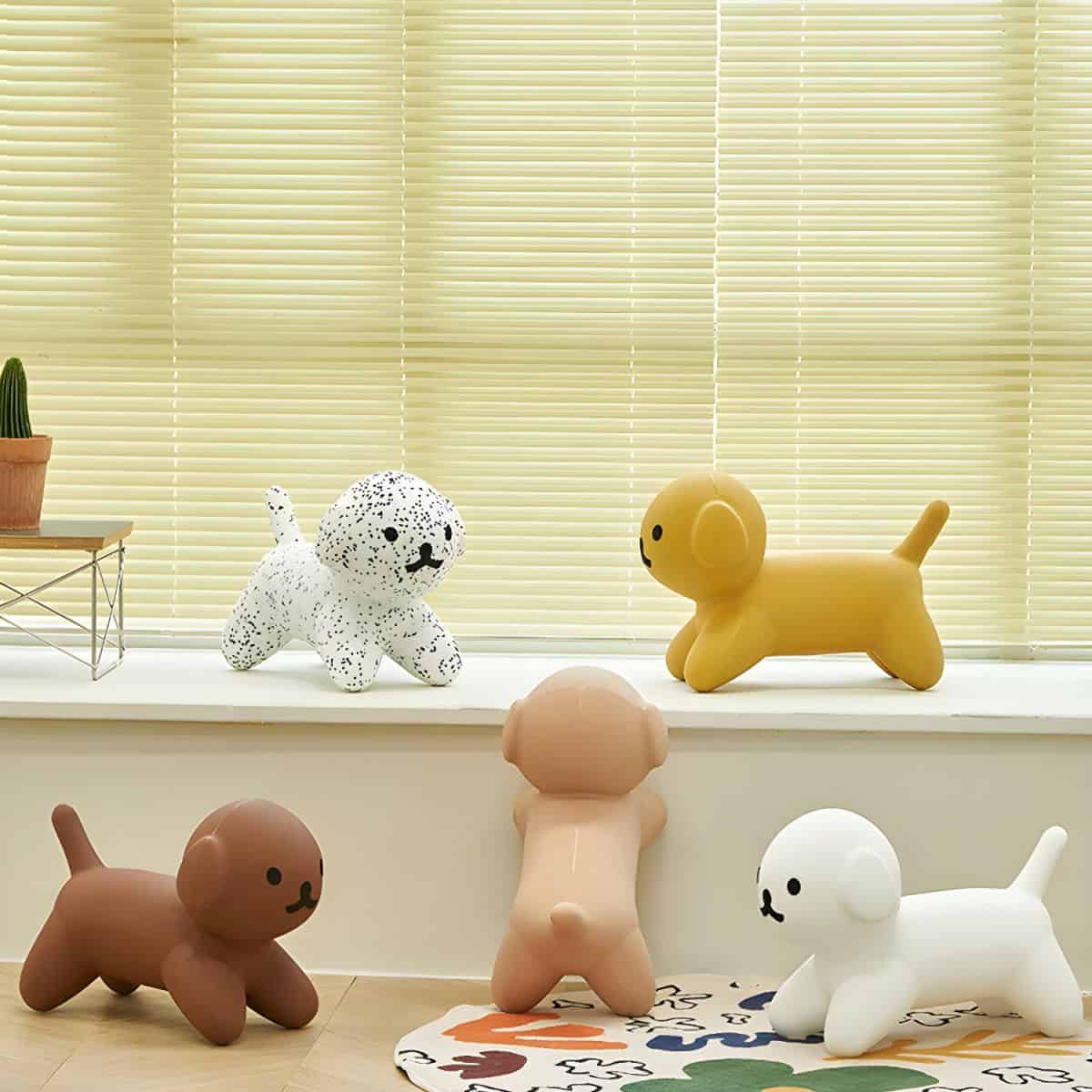 Cute dog-shaped decor toys in various colors on window sill and floor, ideal for children's rooms or playful home decor, emphasizing style, comfort, and fun.