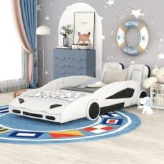 Modern car-shaped kids bed in a playful nursery decorated with stars and a life buoy wall decor, perfect for a child's bedroom or play area.