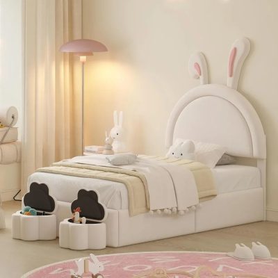 Cute bunny-themed children's bed with a white plush design, bunny ear headboard, sides, and soft accessories, perfect for a cozy and playful bedroom decor.