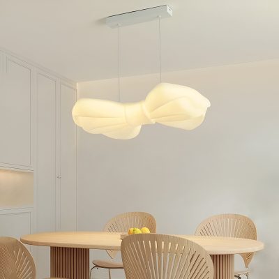 Elegant modern pendant lamp with a butterfly-inspired design illuminating a minimalist dining area. Perfect for stylish, contemporary interiors and enhancing decor with unique lighting fixtures.