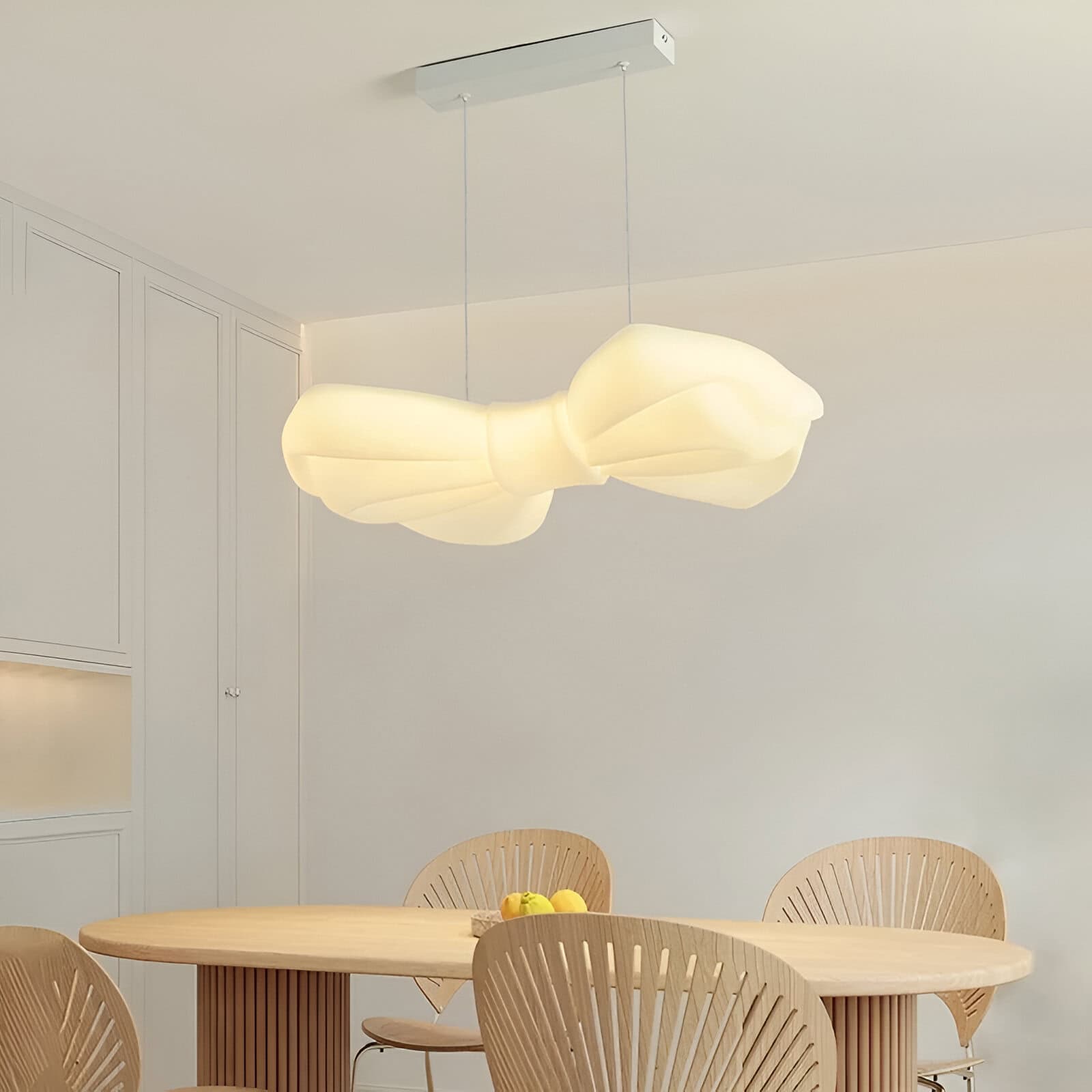 Elegant modern pendant lamp with a butterfly-inspired design illuminating a minimalist dining area. Perfect for stylish, contemporary interiors and enhancing decor with unique lighting fixtures.