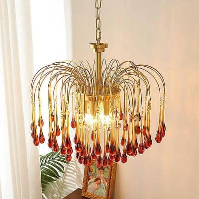 Golden chandelier with amber glass teardrop accents, elegant lighting for home decor or luxury interiors. Perfect for living rooms, dining areas, or elegant interiors.