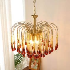 Elegant amber glass chandelier with gold accents, perfect for luxury interior decor and enhancing living room ambiance. Ideal for sophisticated home lighting solutions.