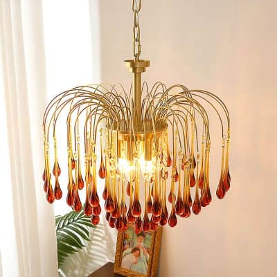 Elegant amber glass chandelier with gold accents, perfect for luxury interior decor and enhancing living room ambiance. Ideal for sophisticated home lighting solutions.
