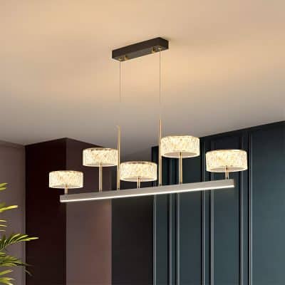 Elegant modern chandelier with multiple illuminated drum shades, perfect for stylish interior lighting, available at Monalisa Medical Store.