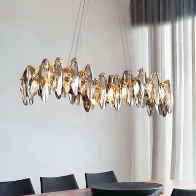 Elegant crystal chandelier hanging above a modern dining table, enhancing luxury ambiance in a Monalisa Store interior, perfect for upscale interior decor and lighting solutions.