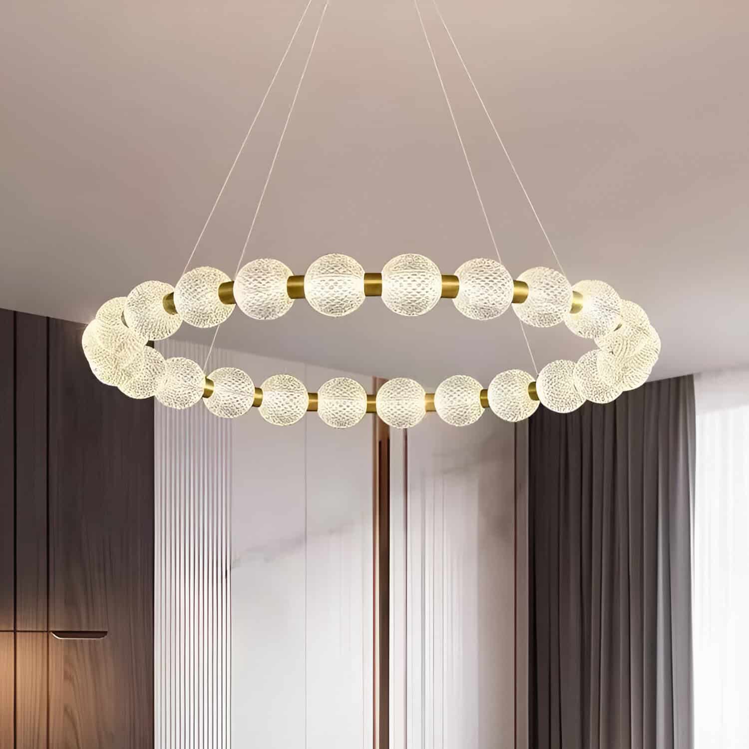 Luxurious modern pendant chandelier with textured glass orbs and gold accents, perfect for stylish living room or dining area decor.
