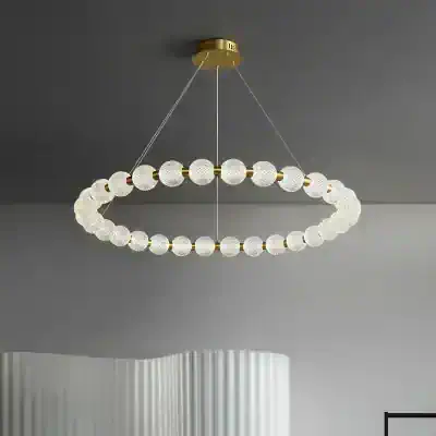 Elegant modern chandelier with crystal glass globes and gold accents, ideal for luxury interior lighting.