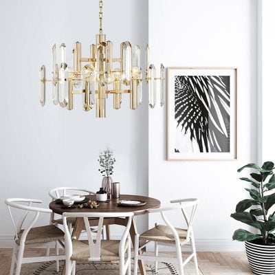 Elegant modern chandelier with gold accents hanging above a stylish dining table in a contemporary Monalisa Store interior. Perfect for enhancing luxury and sophistication in home decor.