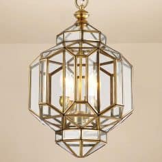 Elegant brass and glass pendant chandelier with multiple candle-style lights, ideal for luxury home or hotel decor.
