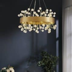 Modern gold chandelier with glass globes, perfect for luxury interior design and elegant lighting solutions at Monalisa Store. Unique lighting fixture for sophisticated spaces.
