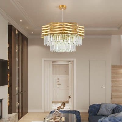 Luxury modern chandelier in elegant living room interior with white walls, wooden accents, cozy blue sofa, and sophisticated decor for upscale home lighting design.