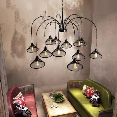 Elegant industrial-style chandelier with multiple exposed bulbs over a cozy sitting area at Monalisa Medical Store. Perfect for modern and stylish medical practice settings.