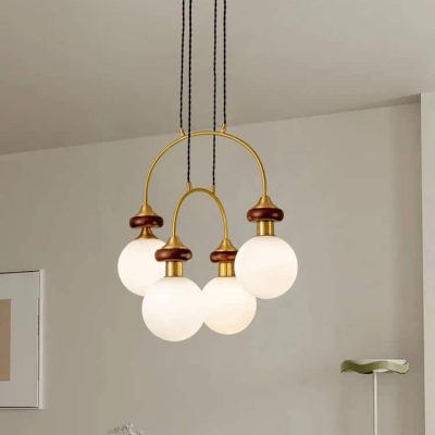 Elegant modern chandelier with white globe lights and brass accents, ideal for enhancing lighting and decor in contemporary home interiors.