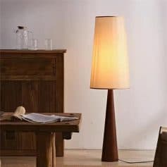 Modern wooden floor lamp with beige lampshade for living room decor.