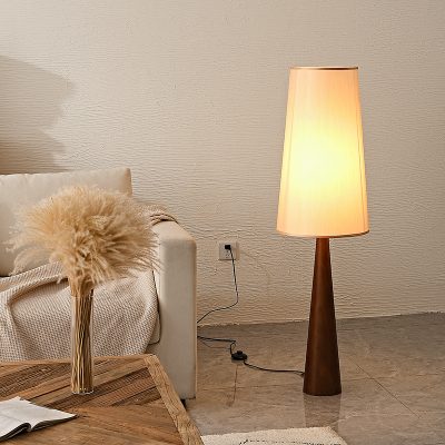 Soft beige floor lamp with a wooden base in modern interior decor. Perfect for creating a cozy ambiance in a contemporary living room. Ideal for stylish home lighting and decorative purposes.