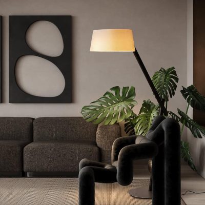 Modern stylish living room featuring comfortable sofa, elegant floor lamp, and lush Monstera plants, perfect for a cozy ambiance at Monalisa Store.