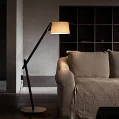 Floor lamp next to a beige sofa in a modern living room, stylish interior decor, ambient lighting, contemporary home furniture, Monalisa Medical store interior aesthetics.