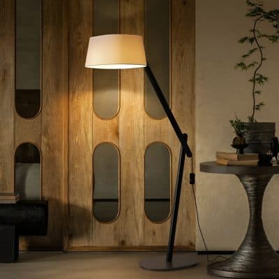 Contemporary floor lamp with adjustable arm and beige lampshade, modern interior design, warm lighting, stylish home decor, perfect for living rooms or reading areas.