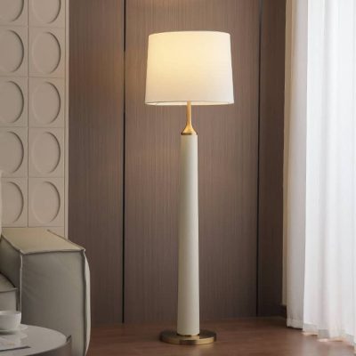Elegant modern floor lamp with white shade in stylish living room setting.